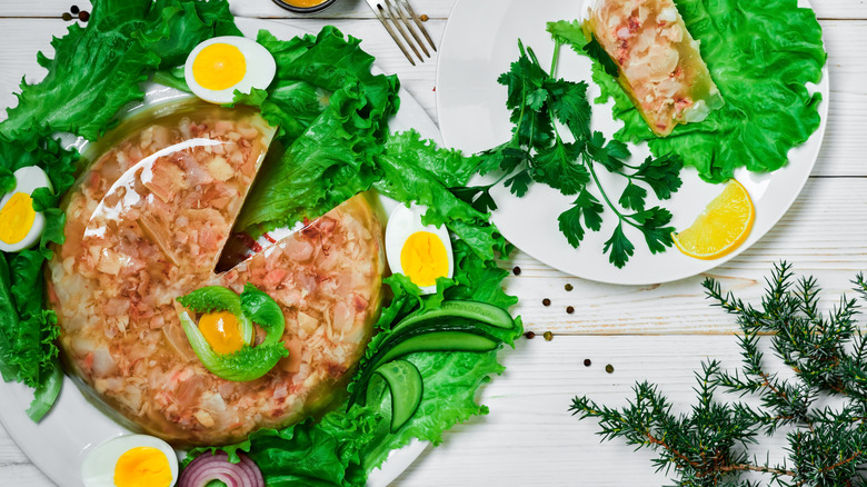 aspic salads with meet over green lettuce and herbs