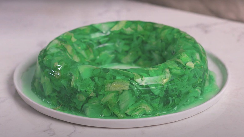 green perfection salad with various lettuce and vegetables suspended in jell-o