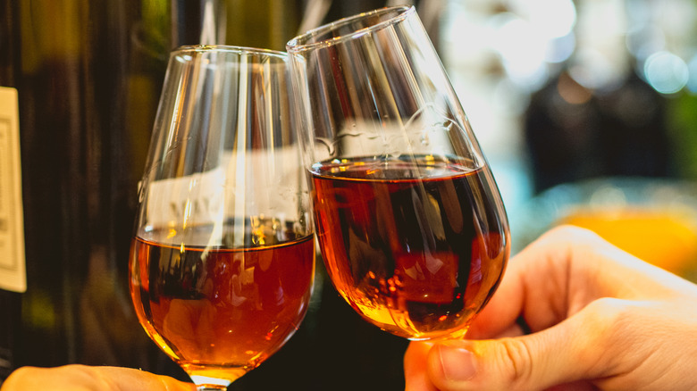 two people toasting with glasses of sherry