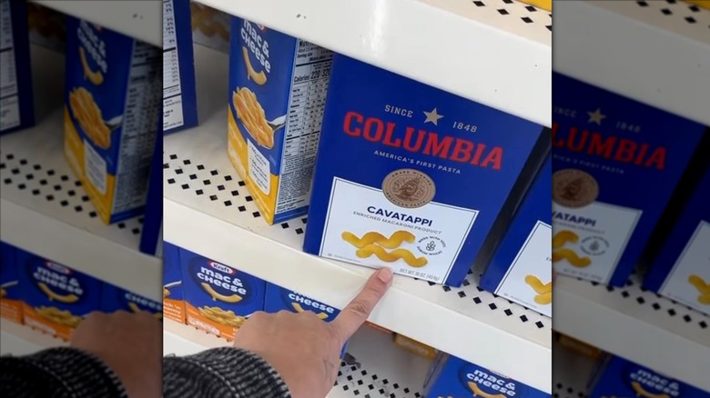 Hand pointing at Columbia brand pasta at Dollar Tree