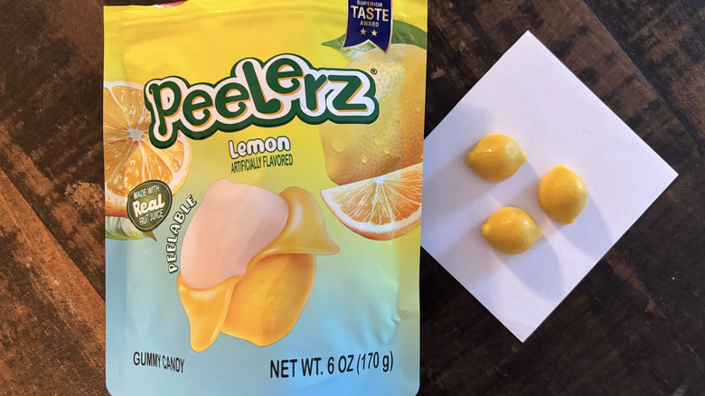 Peelerz lemon flavored gummy candy in bag and paper on wooden table.