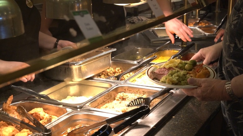 patrons scooping food from a buffet table at bird-in-hand family restaurant