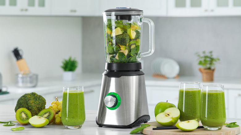 Mixed fruits and vegetables in a blender, ready for a smoothie