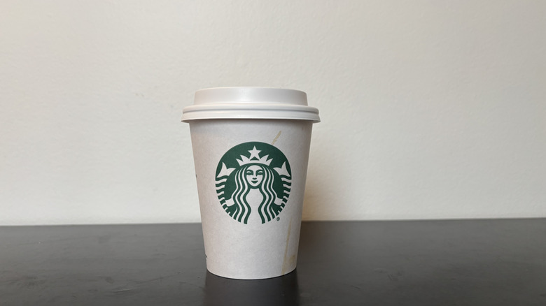 starbucks coffee cup on black table