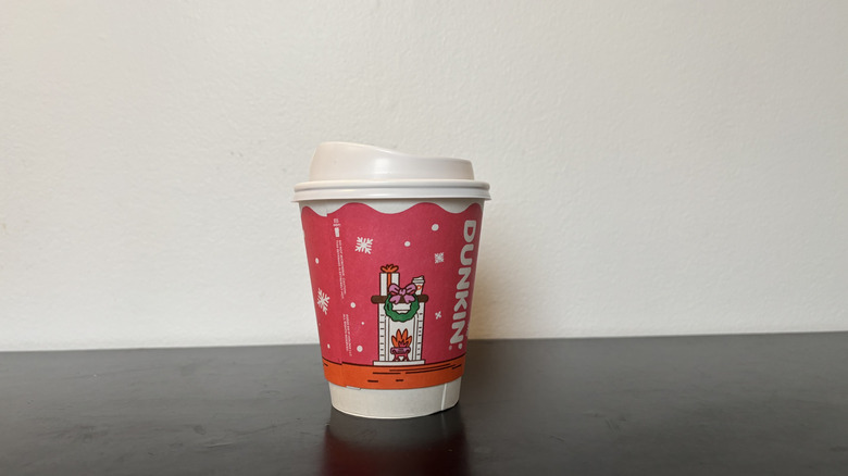 dunkin donuts coffee cup on black table