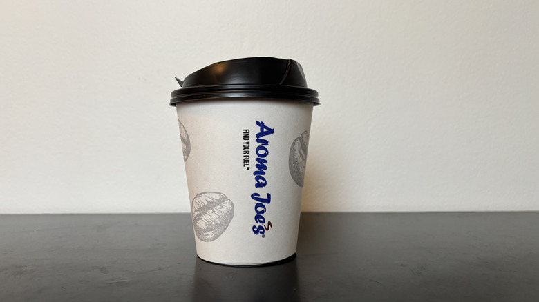 aroma joe's coffee cup on black table