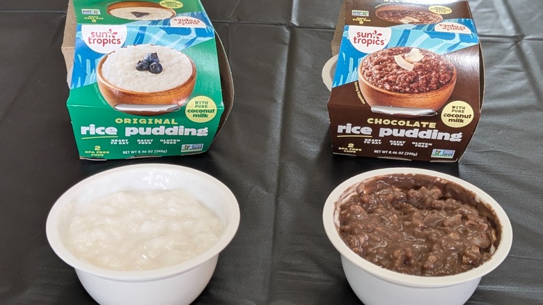 Paper packs of plain and chocolate Sun Tropics coconut rice pudding next to plastic cups of pudding