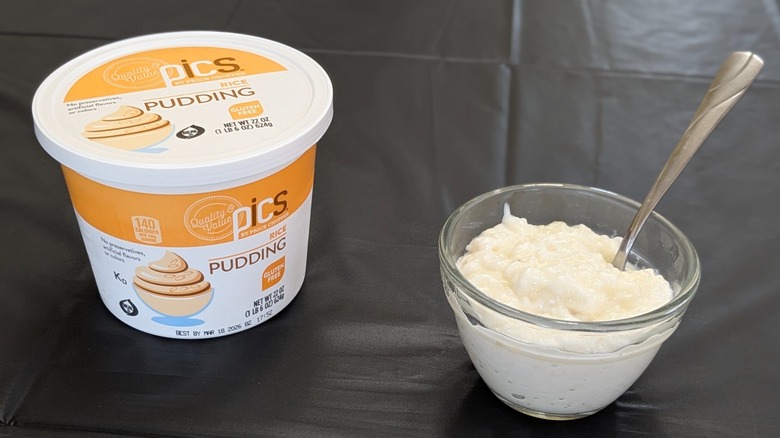 A plastic container of PICS rice pudding next to a glass of bowl of rice pudding with a spoon in it