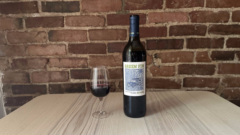 Bottle of Green Fin Red Wine on wooden table