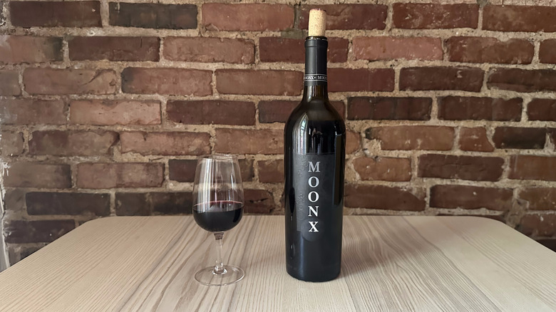 Bottle of Moon X Red Wine on wooden table
