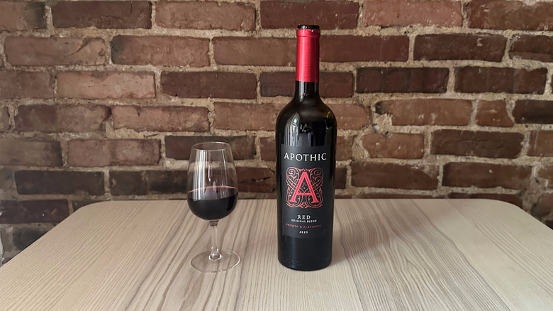 Bottle of Apothic red wine on wooden table