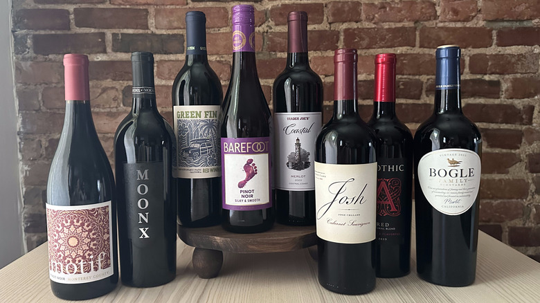 Bottles of value red wine on wooden table