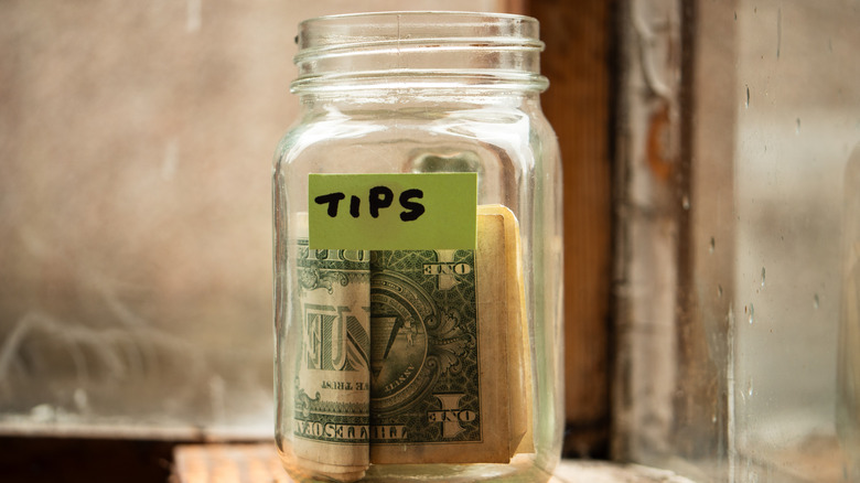 Tip jar on wooden surface
