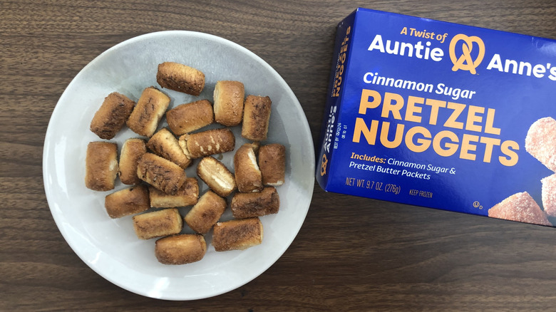Auntie Anne's cinnamon sugar pretzel nuggets on a plate next to the packaging