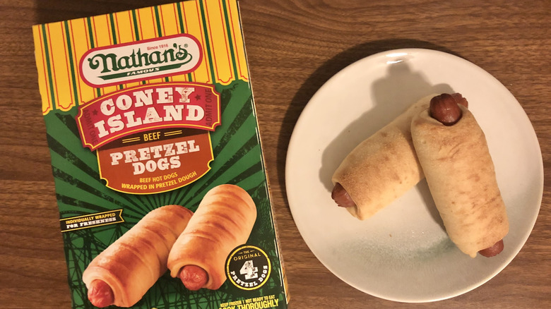 Nathan's Coney Island pretzel dogs on a plate next to the packaging