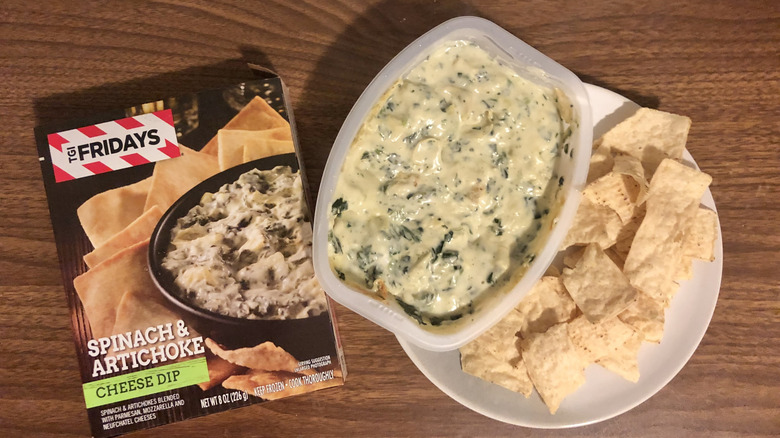 TGI Fridays spinach and artichoke cheese dip on a plate next to the packaging