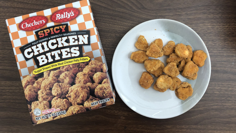 Checkers and Rally's spicy chicken bites on a plate next to the packaging