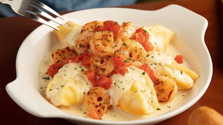 Olive Garden giant stuffed shells with shrimp in white dish