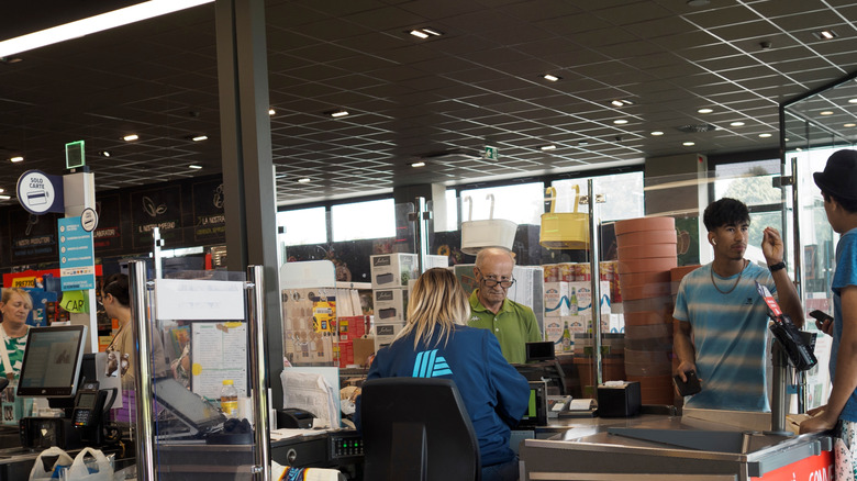 Customers paying for groceries at the checkout counter of ALDI
