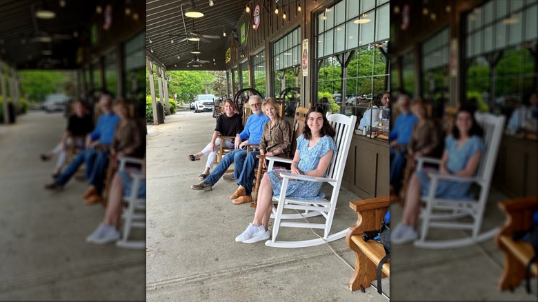 People sitting in rocking chairs outside of Cracker Barrel