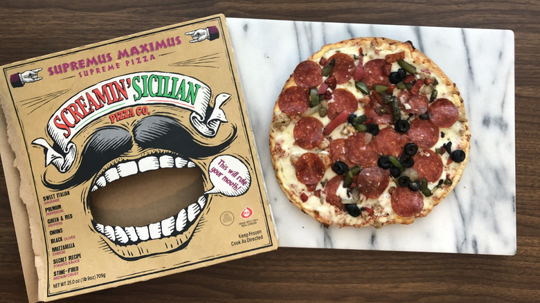 Screamin' Sicilian Supremus Maximus supreme pizza on cutting board.