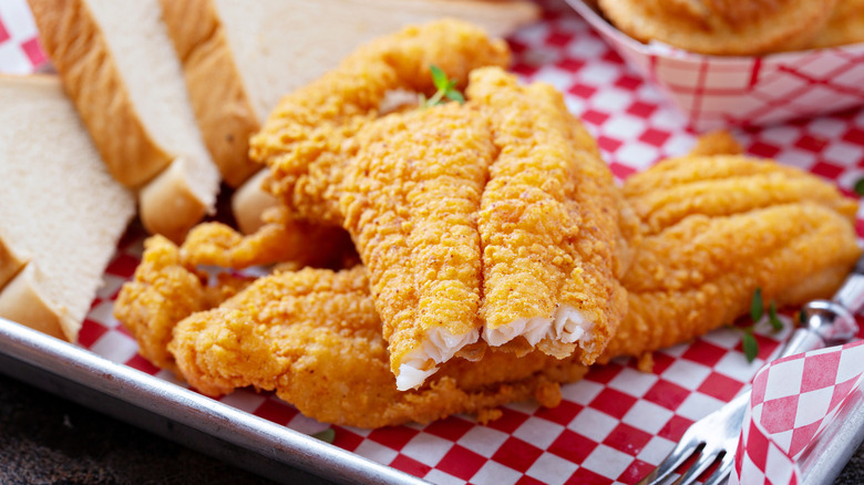 Southern-style fried fish with Texas toast on a paper-lined tray
