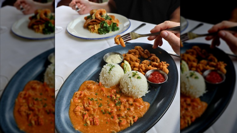Shrimp étouffée, rice, and fried shellfish on a grey plate
