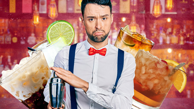 Bartender with shaker and cocktails
