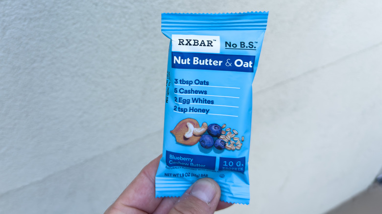 Hand holding a blue RXBar
