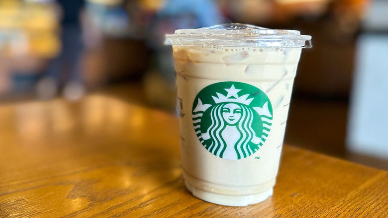Starbucks iced vanilla latte on wooden table