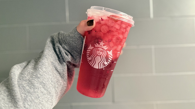 A person holding Thanksgiving Sangria drink in front of tile background