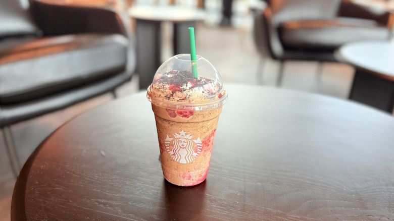 Wolf Man Starbucks drink on a wooden table inside Starbucks