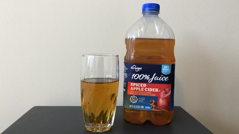Kroger 100% juice spiced apple cider in a glass.