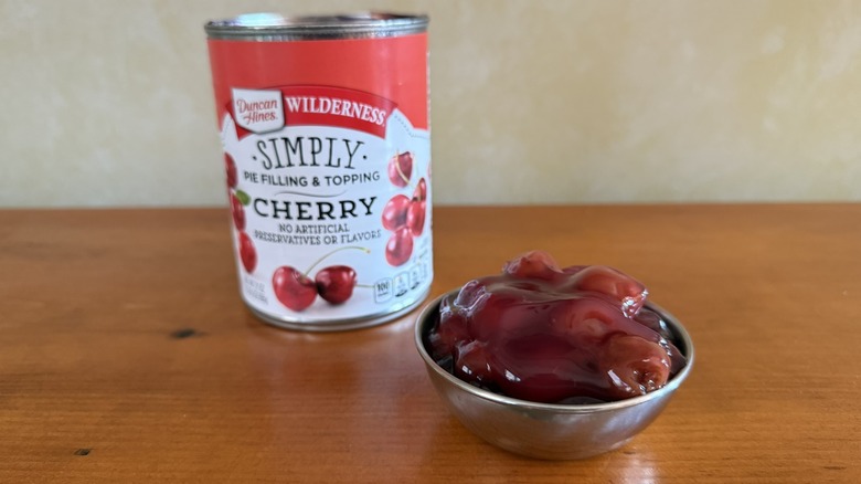 Bowl of cherry pie filling in front of can