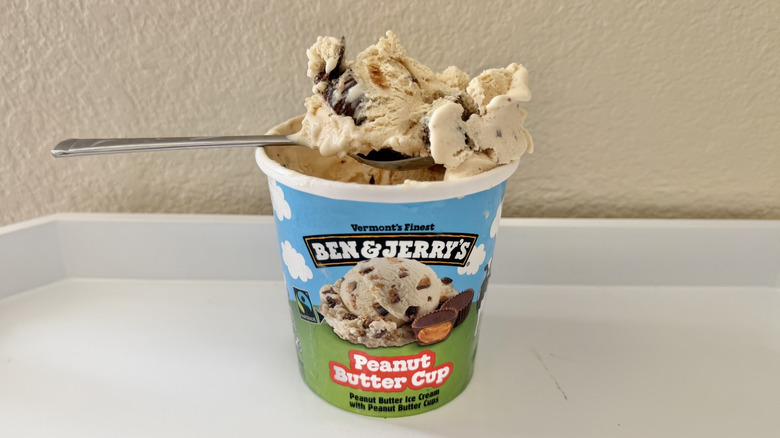 Ben & Jerry's Peanut Butter Cup Ice Cream on a spoon placed on a pint of ice cream