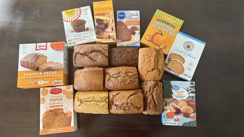 Eight loaves pumpkin bread surrounded by boxes from different brands