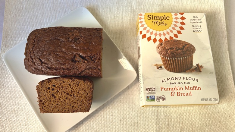 Baked loaf Simple Mills Almond Flour Pumpkin Muffin & Bread Baking Mix with a slice on a plate next to box