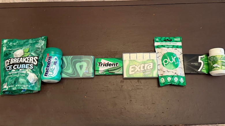 Various types of sugar free spearmint gum lined up on table