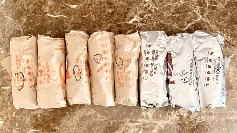 Overhead image of wrapped Taco Bell burritos lined up in a row