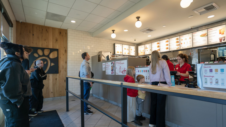 Customers ordering food at the counter at Chick-Fil-A