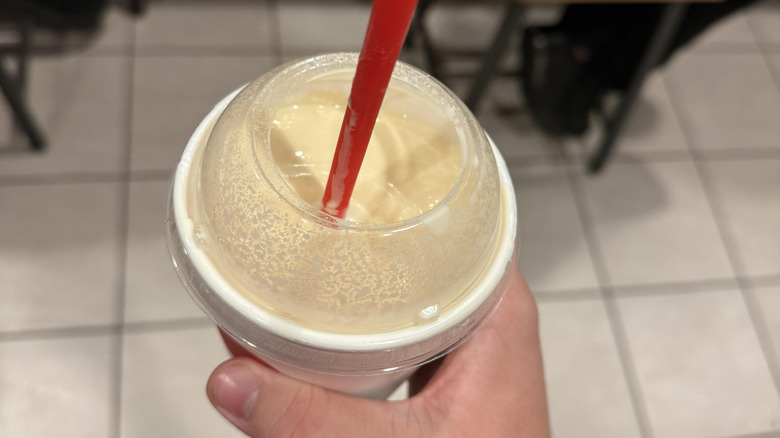 Close up of hand holding Chick-Fil-A milkshake