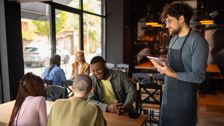 Server waiting to take a table's order