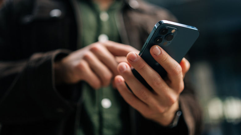 Bottom up image of a hand holding a phone
