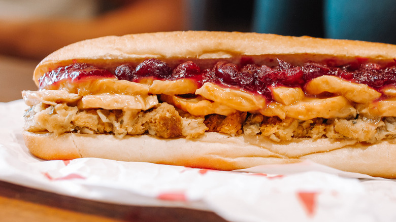 Close-up image of one side of Wawa gobbler sub with the sauce oozing out