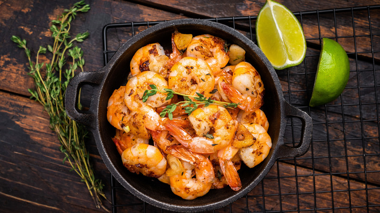 cooked shrimp in small skillet with thym