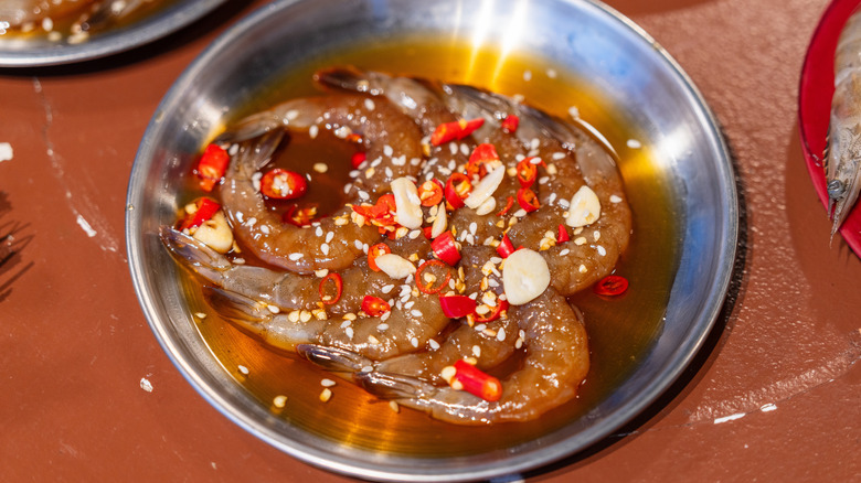 shrimp marinating in sauce, garlic, and chilies