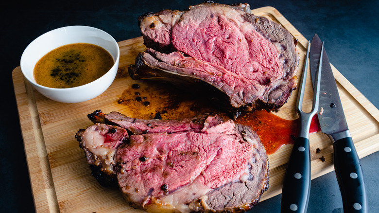 prime rib with au jus on cutting board