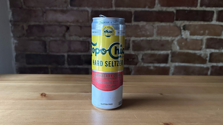 Topo Chico Strawberry Guava Seltzer on wooden table