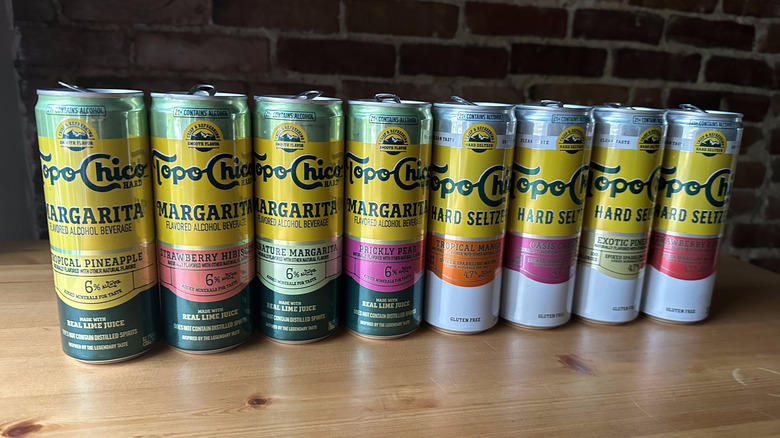 Topo Chico hard beverage cans on wooden table