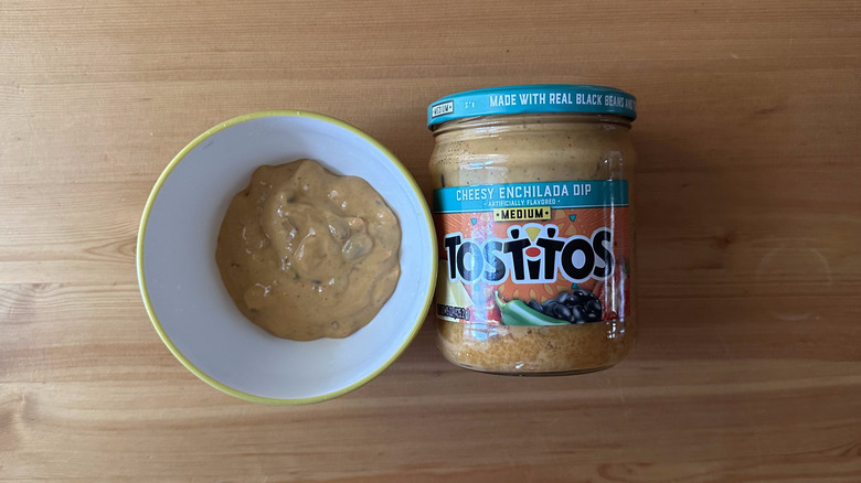 Tostitos Medium Cheesy Enchilada Dip in bowl on wooden table